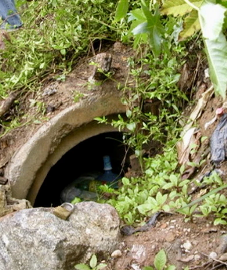 Real photograph of the entrance to the concrete pipe used as the captivity site